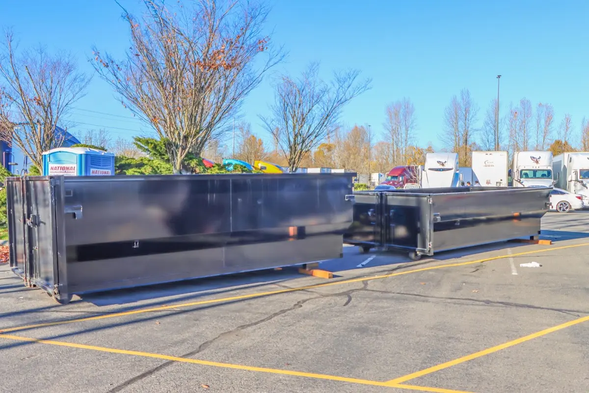 Professional dumpster rental service with roll-off container on residential driveway in Forest Lake